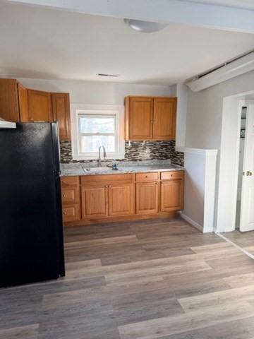 2 West 10th Street, Unit 2 Lowell, MA 01850 - Photo 10 of 13 a kitchen with granite countertop a refrigerator and a sink