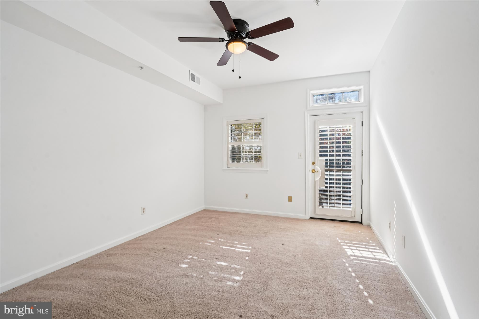 1314 Garden Wall Circle, Unit C Reston, VA 20194 - Photo 18 of 26 an empty room with windows and fan