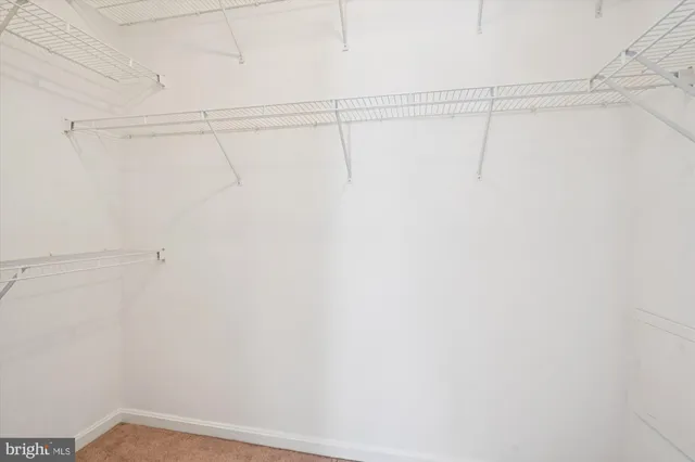 a bathroom with a toilet a sink a vanity and mirror