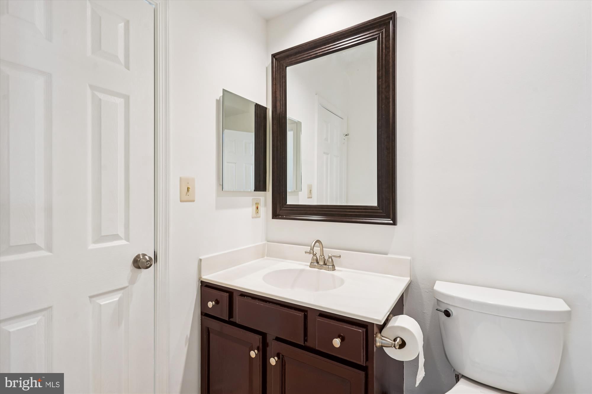 1314 Garden Wall Circle, Unit C Reston, VA 20194 - Photo 22 of 26 a bathroom with a toilet a sink a vanity and mirror