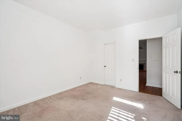 a sign of golf club on a wall under a tree