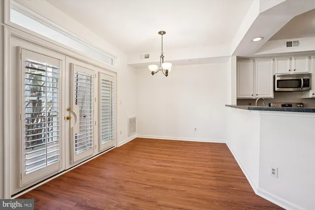 a view of a kitchen with microwave and cabinets