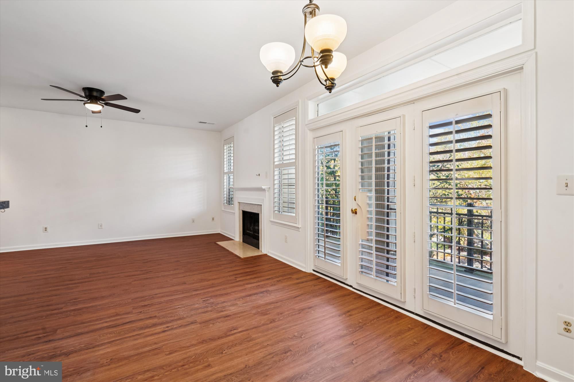 1314 Garden Wall Circle, Unit C Reston, VA 20194 - Photo 8 of 26 a view of an empty room with a window and wooden floor