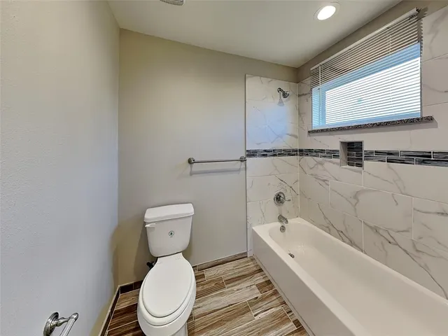 a bathroom with a toilet a sink and bathtub