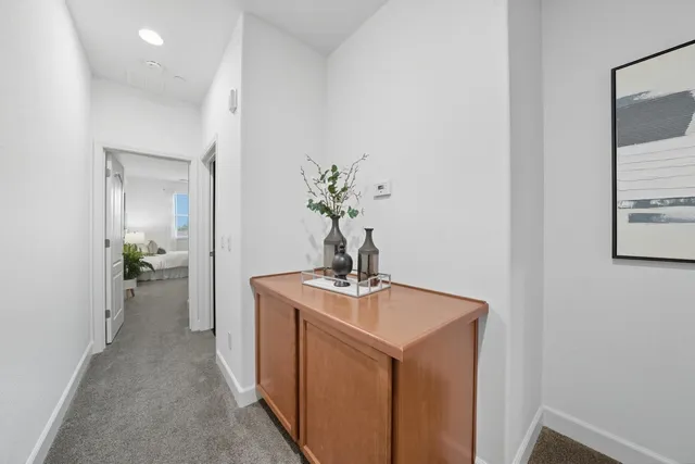 a bedroom with bed a mirror and a window