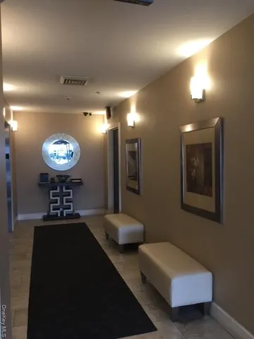 a living room with furniture and a large mirror