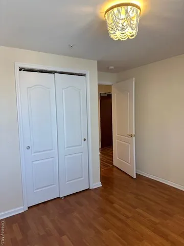a view of an empty room and wooden floor