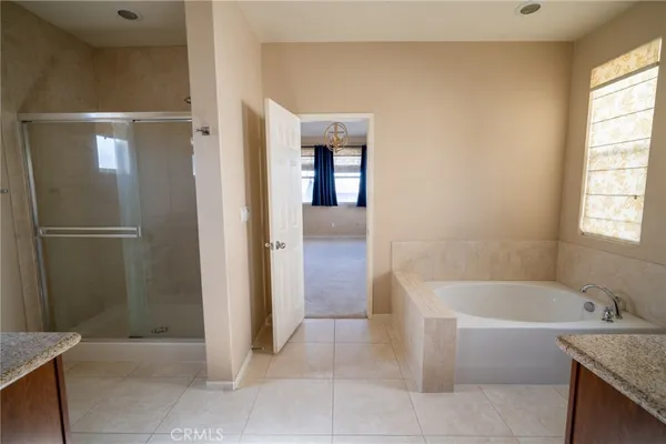 a bathroom with a bathtub and shower