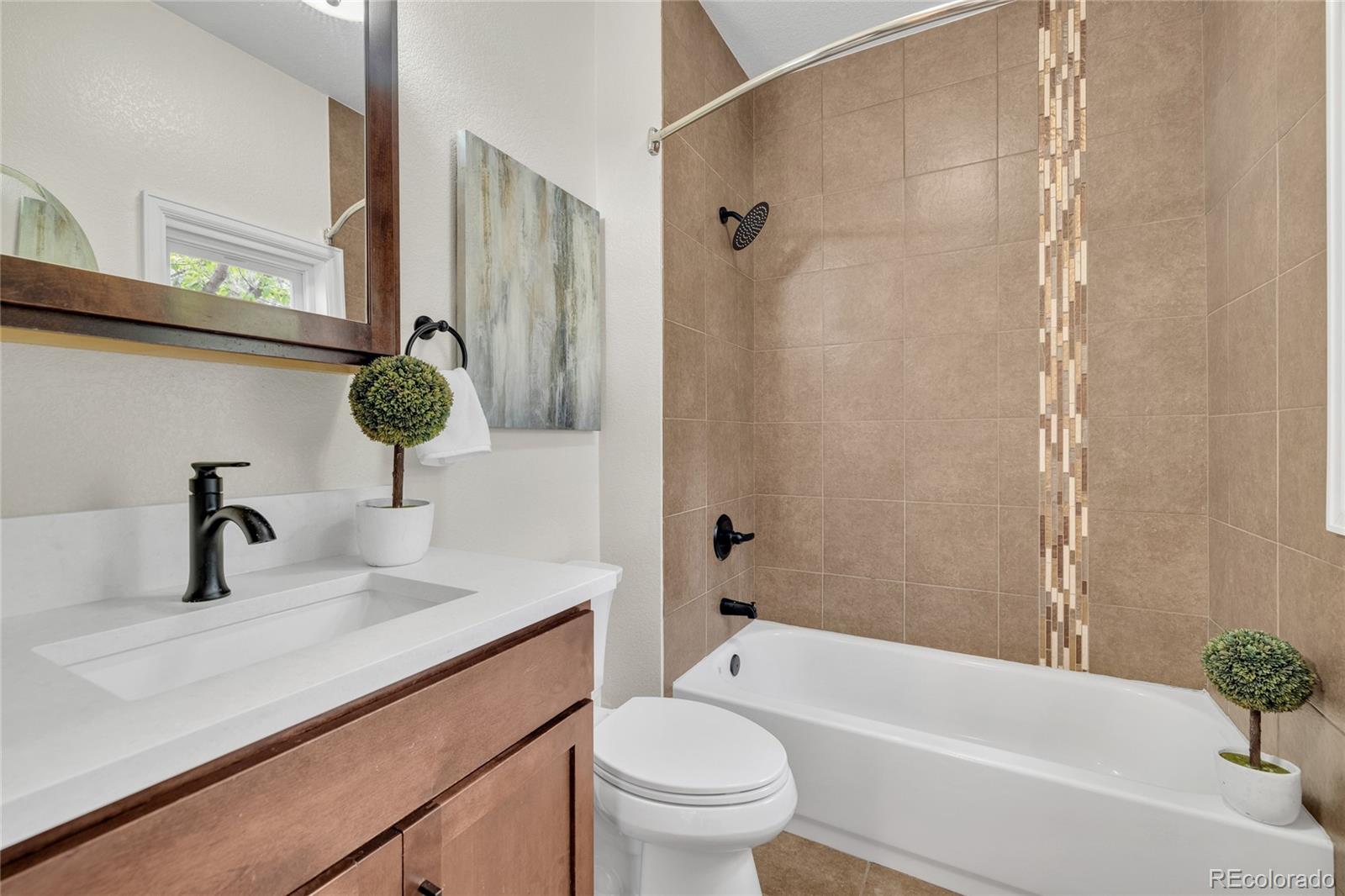2124 Gray Street Edgewater, CO 80214 - Photo 33 of 49 a bathroom with a sink a toilet and shower