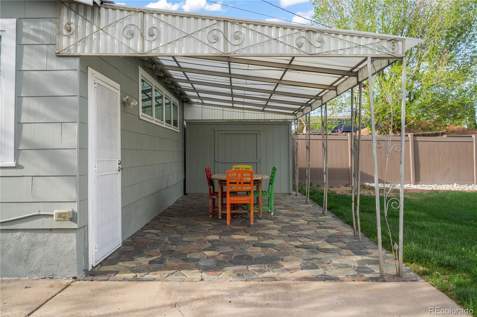 2124 Gray Street Edgewater, CO 80214 - Photo 36 of 49 a backyard of a house with barbeque oven table and chairs