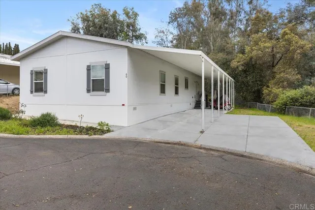 a view of house with backyard and garden