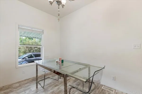 a view of a workspace with furniture and wooden floor