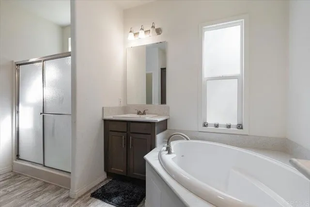 a bathroom with a tub sink and mirror