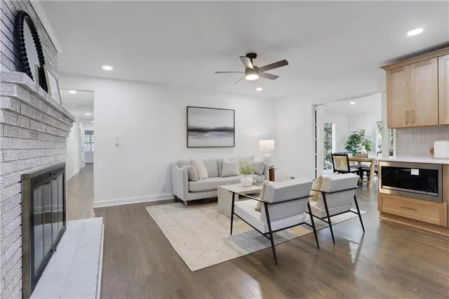 a kitchen with a table chairs microwave and cabinets