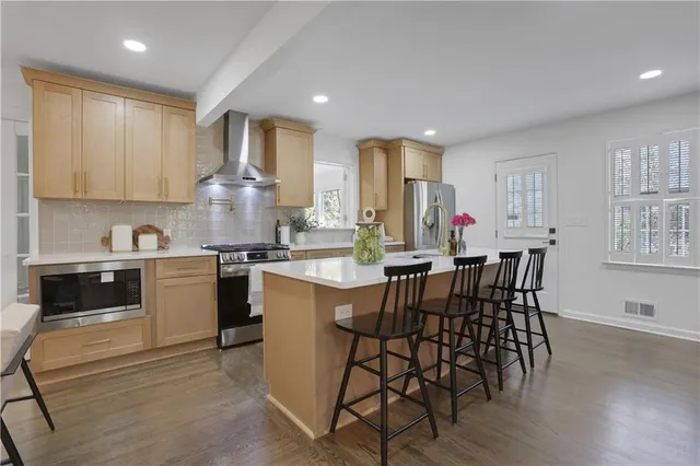 a stove top oven sitting inside of a kitchen