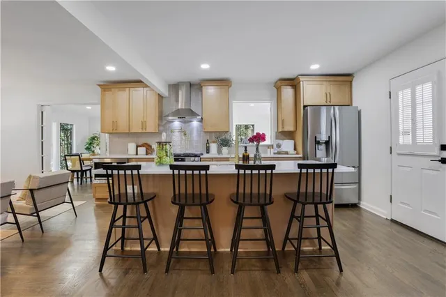a kitchen with stainless steel appliances a sink stove and cabinets