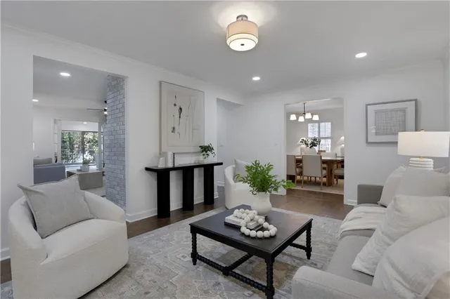 a living room with furniture and large windows