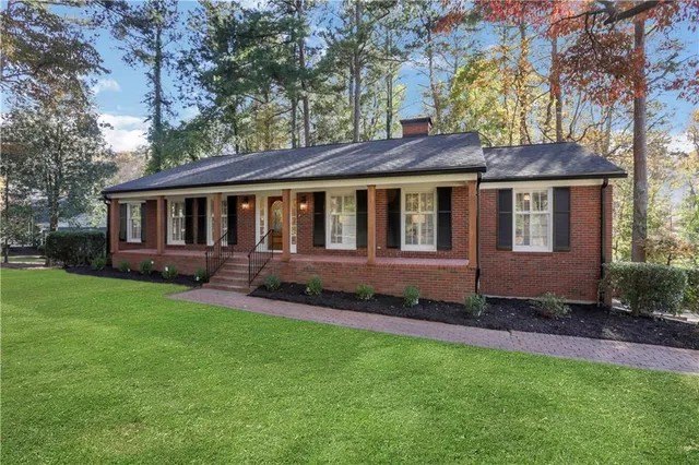 a view of a brick house with large windows