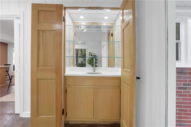 a view of an empty room with wooden floor