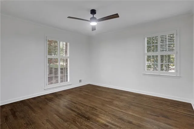 a view of an empty room with wooden floor