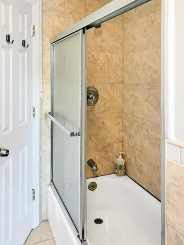 a bathroom with a tub and shower