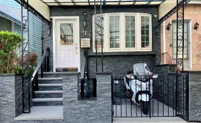 a front view of a house with stairs