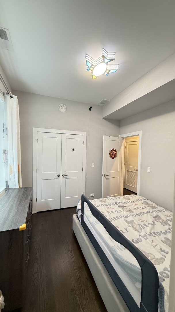 3422 South Normal Avenue Chicago, IL 60616 - Photo 26 of 48 a spacious bedroom with a bed and a chandelier