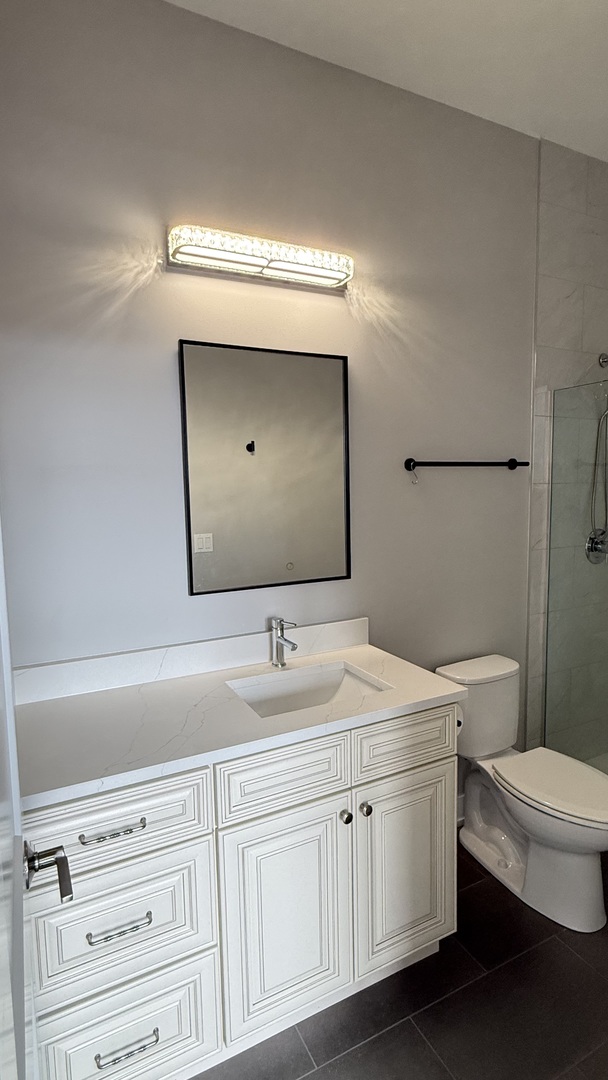 3422 South Normal Avenue Chicago, IL 60616 - Photo 27 of 48 a bathroom with a toilet sink and mirror