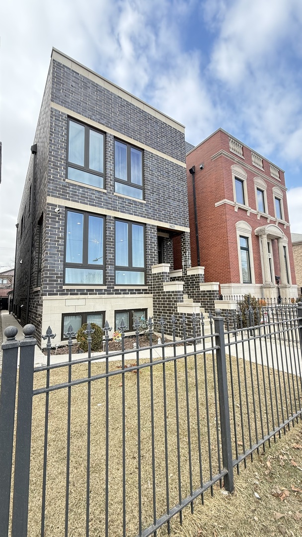 3422 South Normal Avenue Chicago, IL 60616 - Photo 3 of 48 a front view of a building with balcony