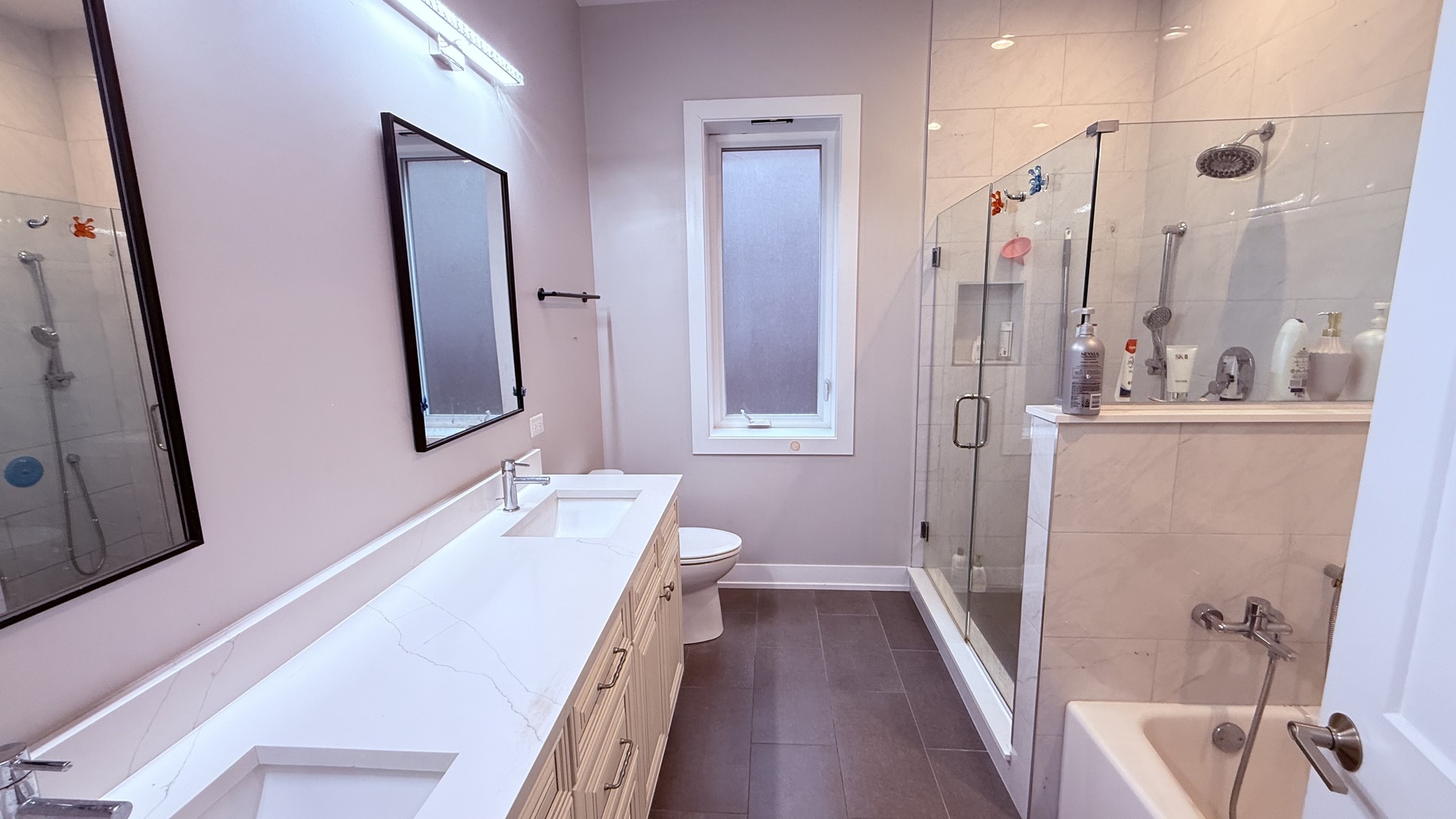 3422 South Normal Avenue Chicago, IL 60616 - Photo 33 of 48 a bathroom with a double vanity sink and a mirror