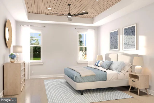 a bedroom with a bed wooden floor and window