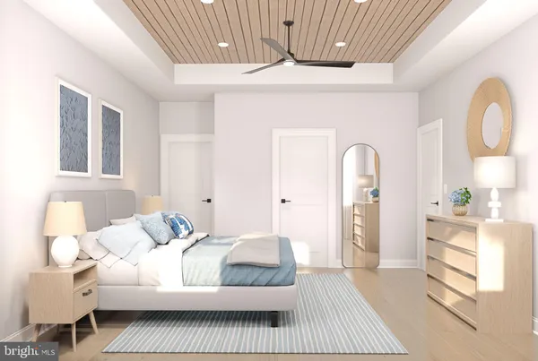 a bedroom with a large bed and a chandelier