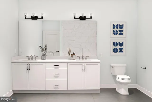 a bathroom with a sink vanity mirror and toilet