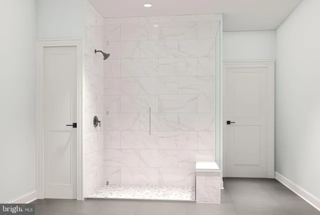 a bathroom with a glass shower door