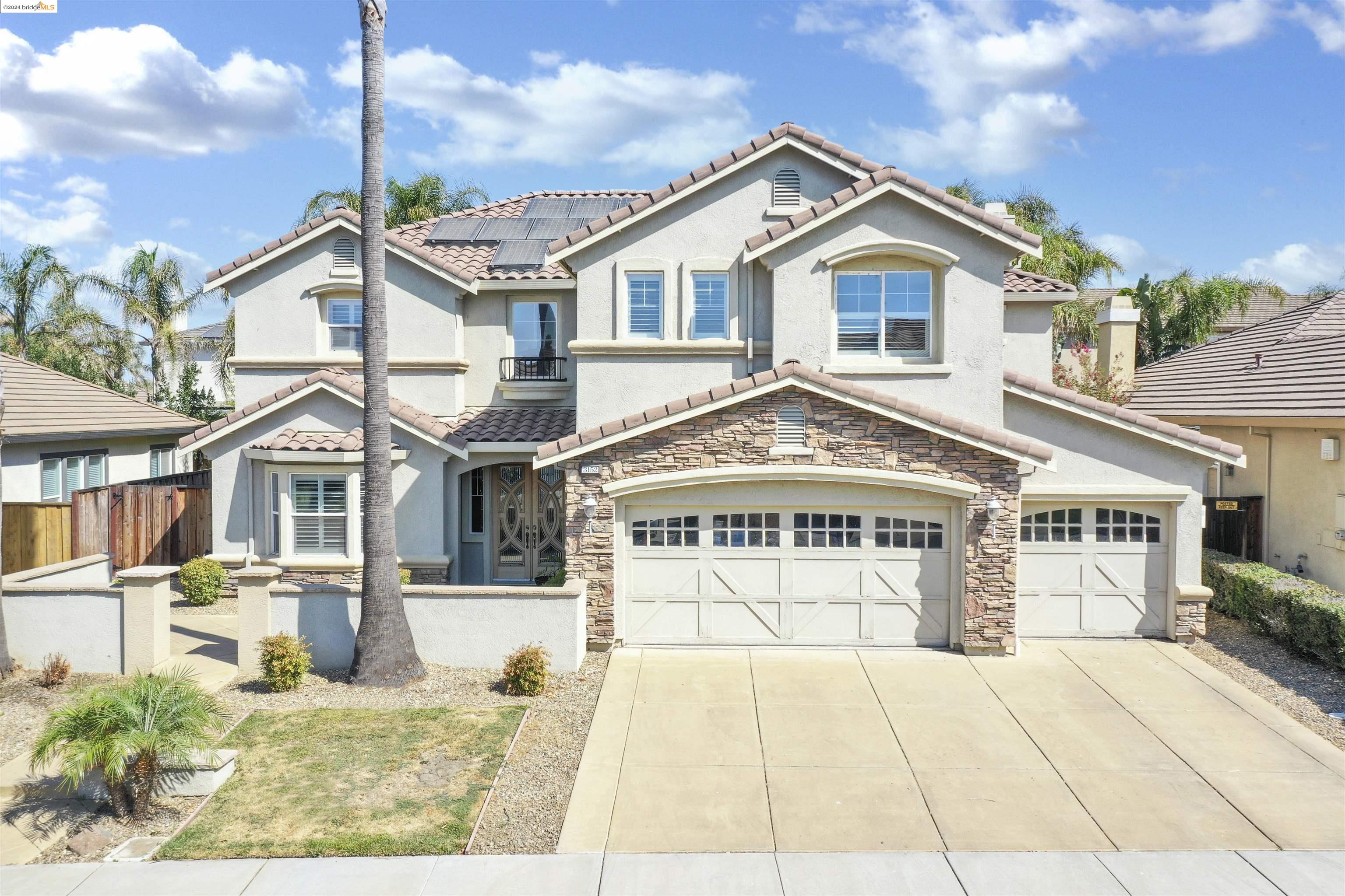 3152 Castle Rock Loop Discovery Bay, CA 94505 - Photo 1 of 1 a view of a white house with large windows and a yard
