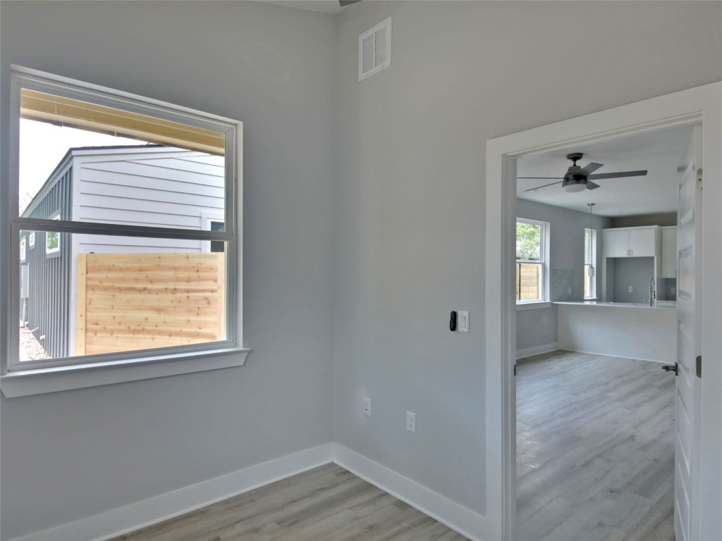 6111 Carnation Terrace, Unit 2 Austin, TX 78741 - Photo 16 of 34 Empty room featuring light wood-type flooring and a ceiling fan