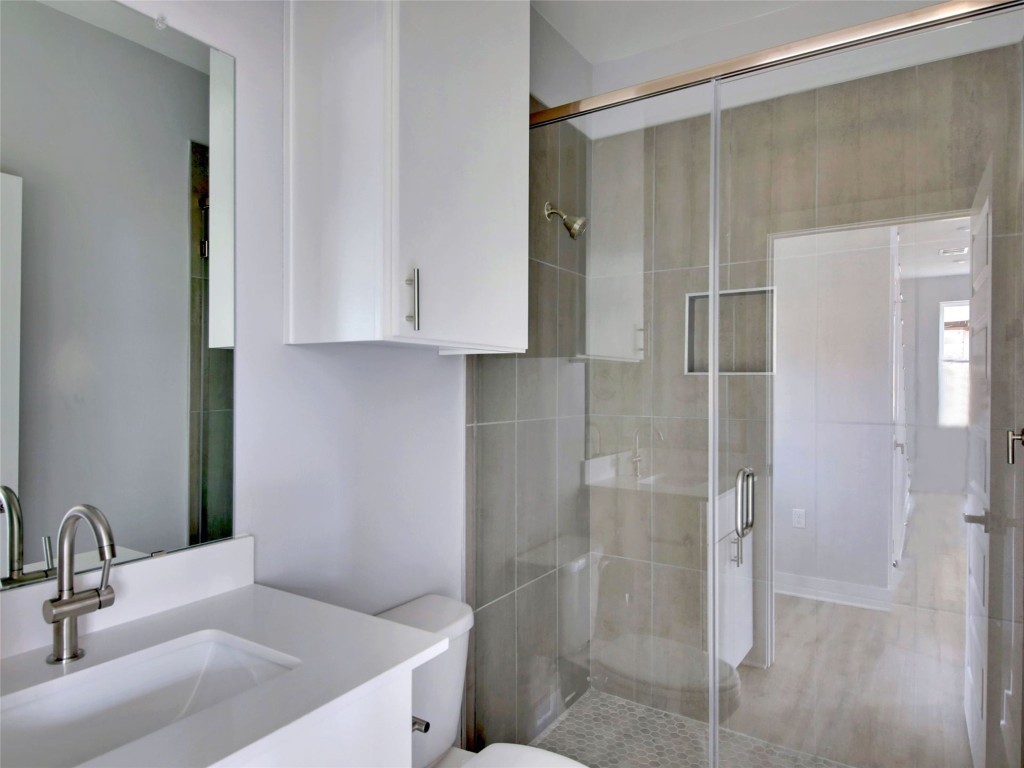 6111 Carnation Terrace, Unit 2 Austin, TX 78741 - Photo 27 of 34 Bathroom featuring vanity and a stall shower