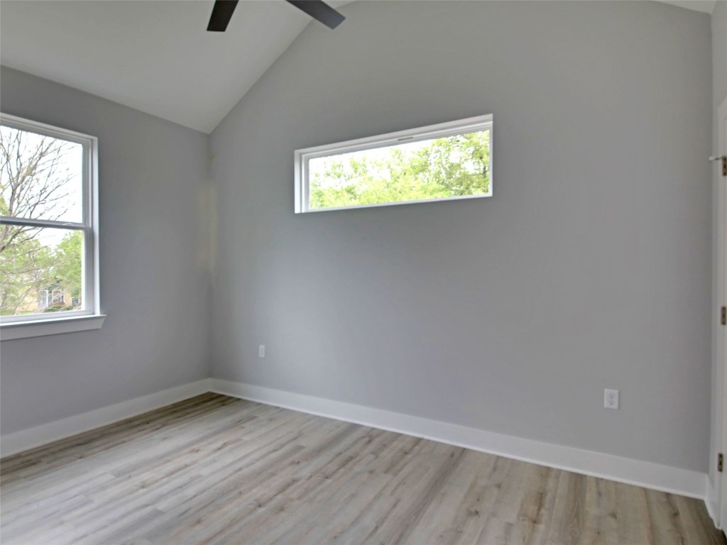 6111 Carnation Terrace, Unit 2 Austin, TX 78741 - Photo 28 of 34 Unfurnished room with lofted ceiling, light wood-type flooring, and ceiling fan