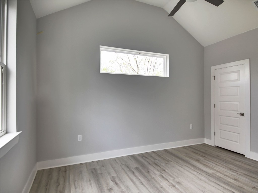 6111 Carnation Terrace, Unit 2 Austin, TX 78741 - Photo 29 of 34 Empty room featuring light wood-style flooring, lofted ceiling, and a ceiling fan