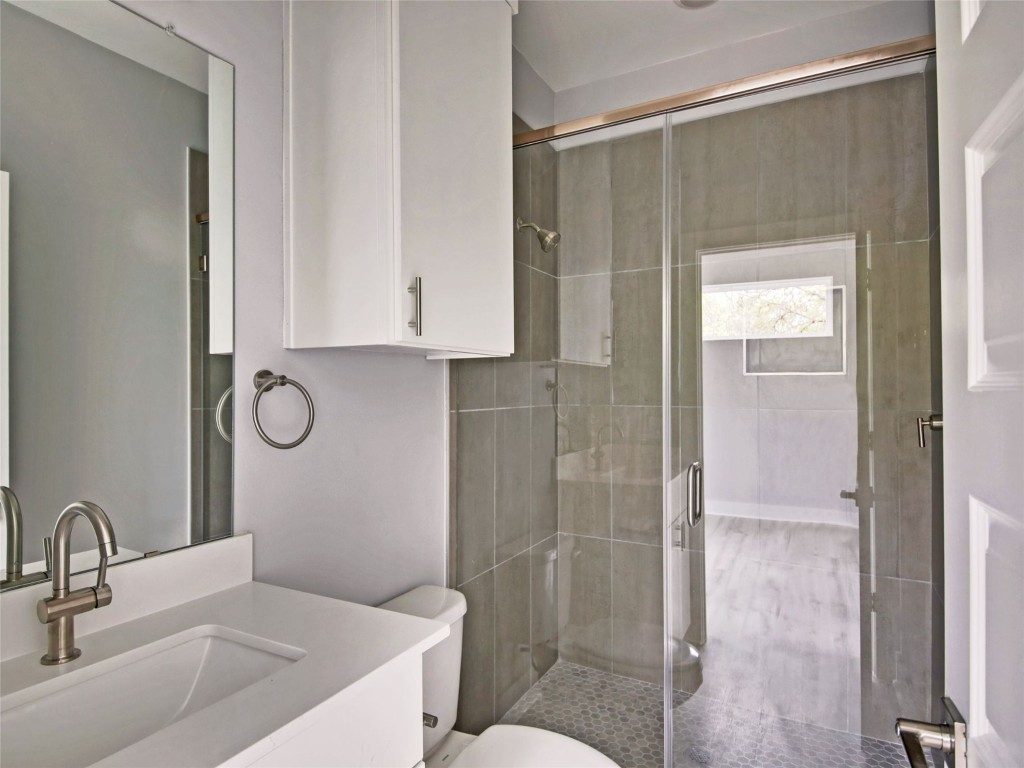 6111 Carnation Terrace, Unit 2 Austin, TX 78741 - Photo 30 of 34 Full bathroom featuring vanity and a stall shower