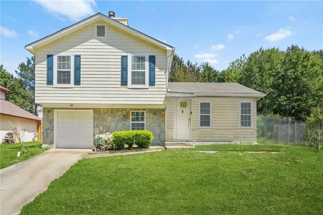 a front view of house with yard and green space
