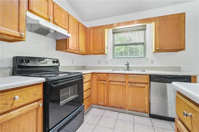 a kitchen with stainless steel appliances granite countertop a sink stove and cabinets