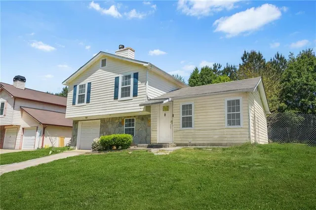 a front view of a house with a garden