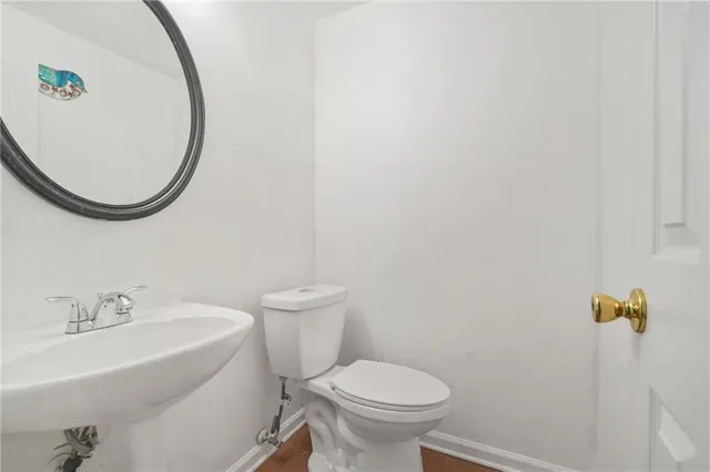 a white toilet sitting next to a bathroom sink