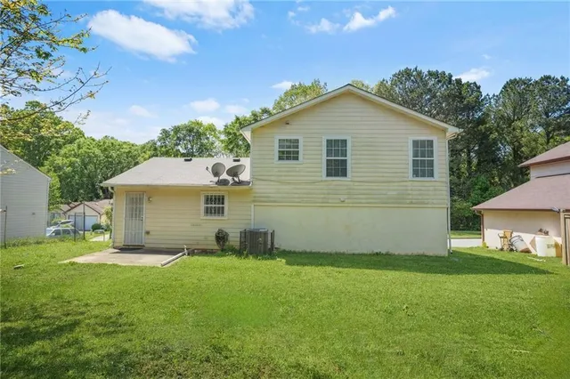 a view of a house with yard and a garden