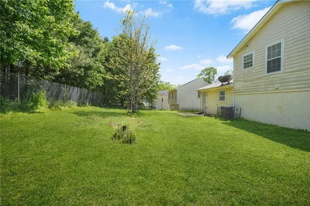 a backyard of a house with lots of green space