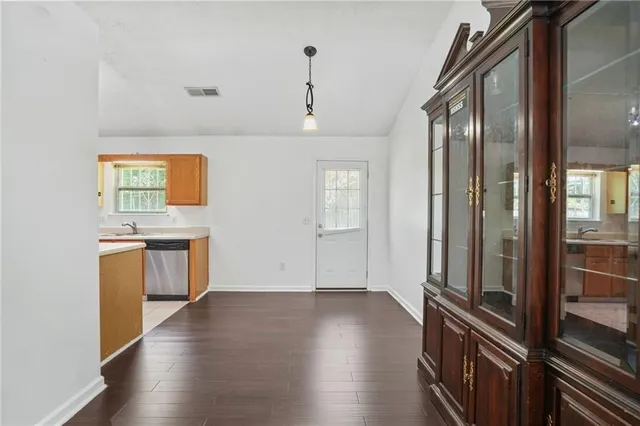a view of a kitchen with a sink and a refrigerator