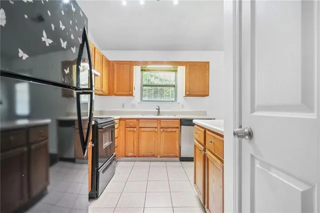 a kitchen with stainless steel appliances granite countertop a sink and a stove