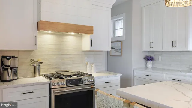 a kitchen with stainless steel appliances a stove and a refrigerator