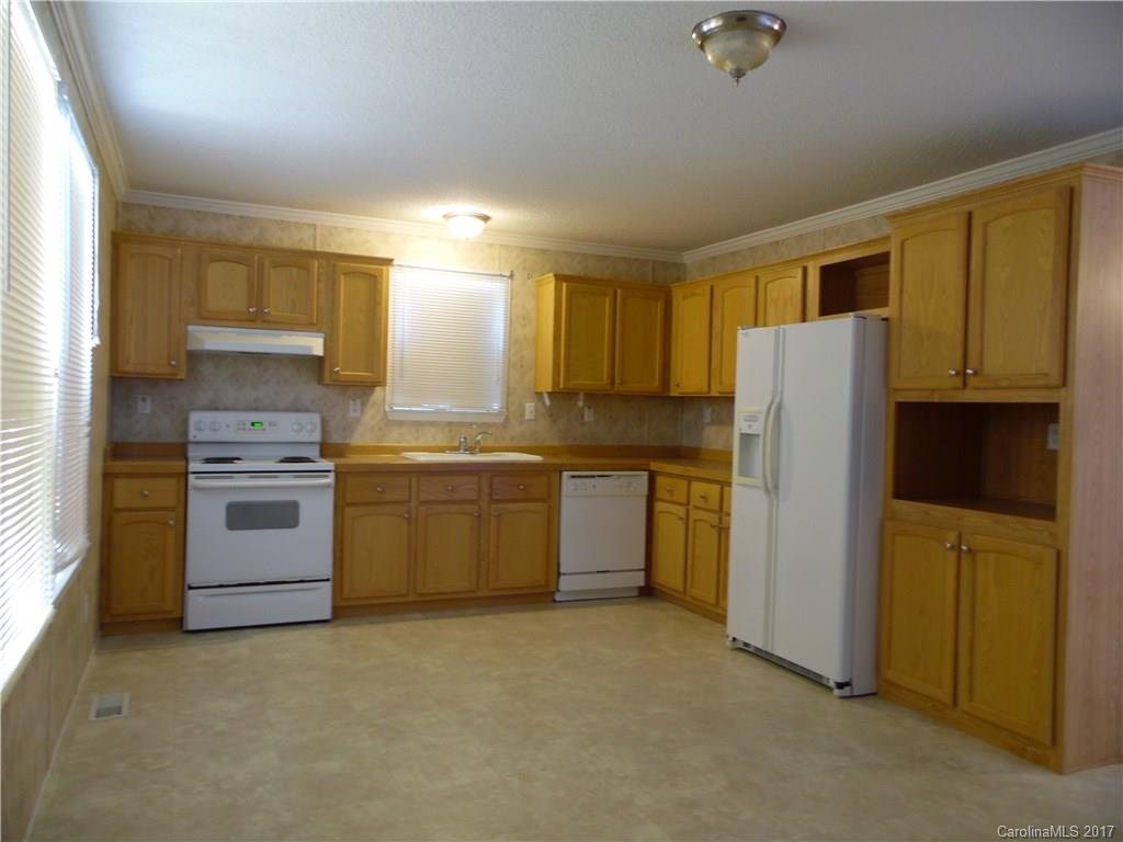 4184 State Rd S-29-304, Unit 2 Lancaster, SC 29720 - Photo 4 of 14 a kitchen with a refrigerator sink and cabinets